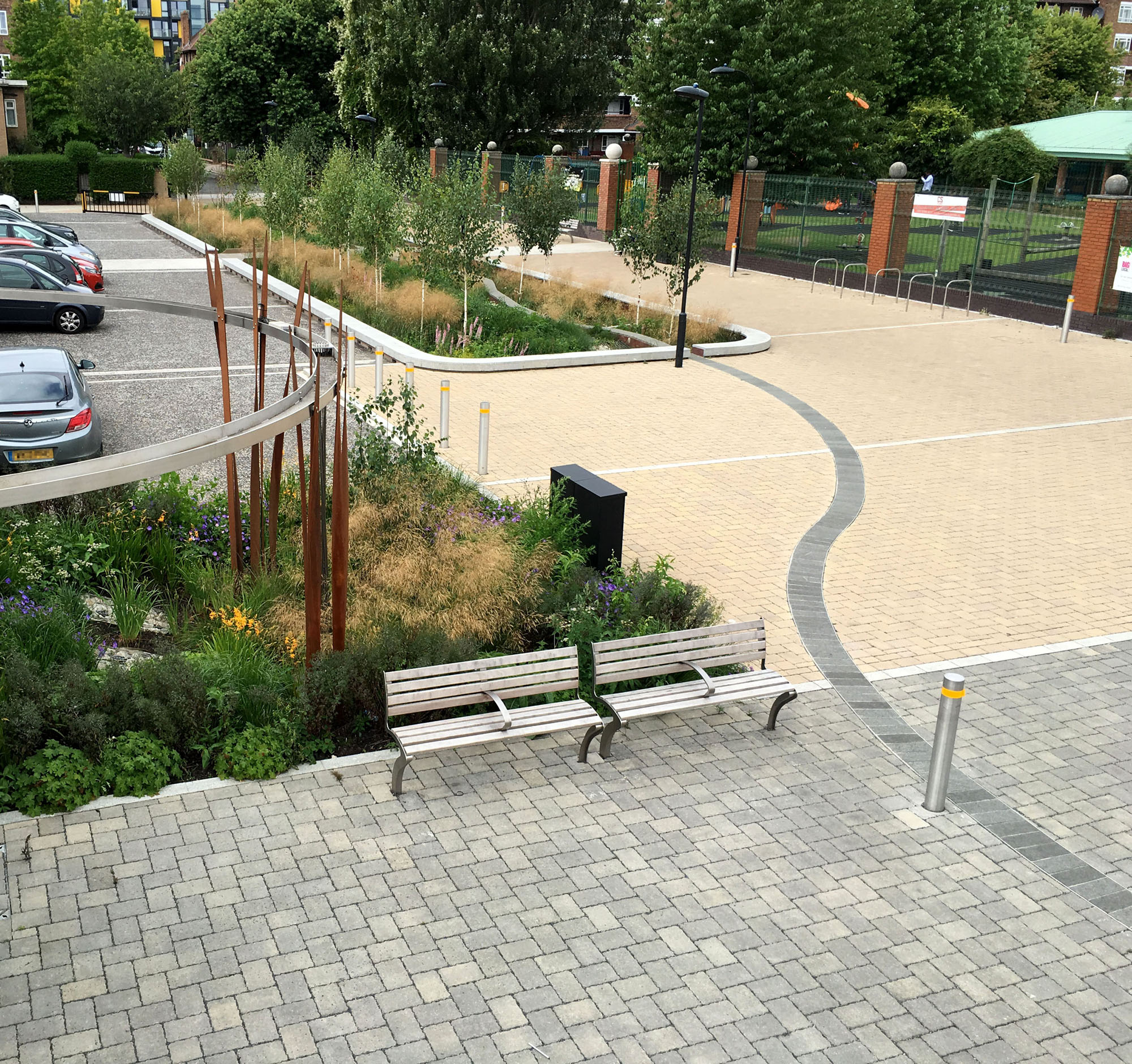 Innovative concrete block overlay paving collects, conveys and cleans rainwater for tree-planted basins at Bridget Joyce Square, London.
